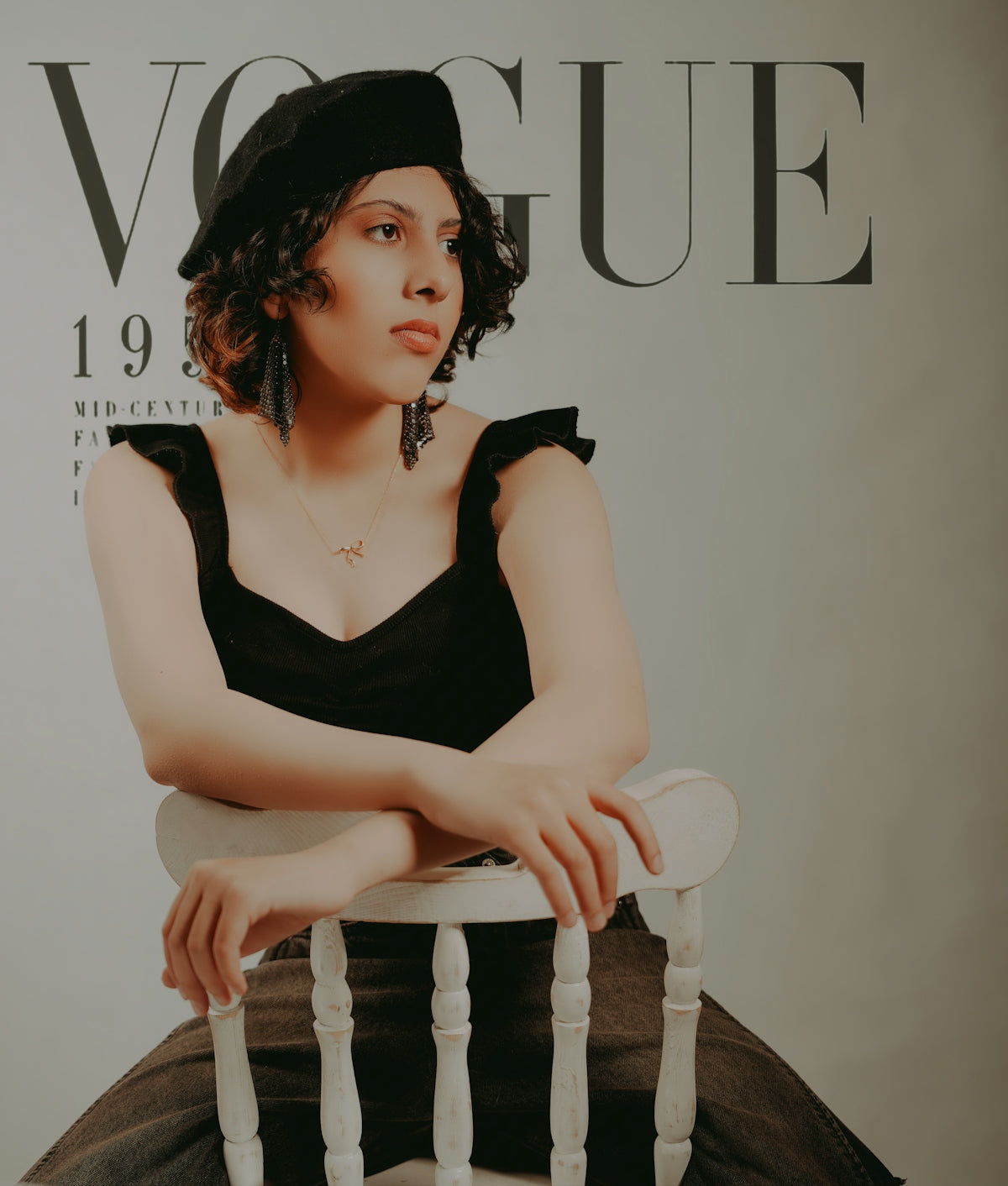 Fashionable woman posing in front of a vogue magazine.