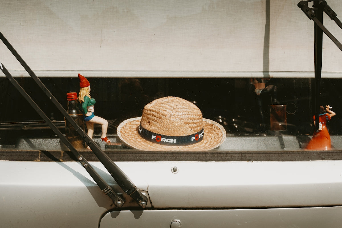 Hats and figurines sit inside a vehicle.