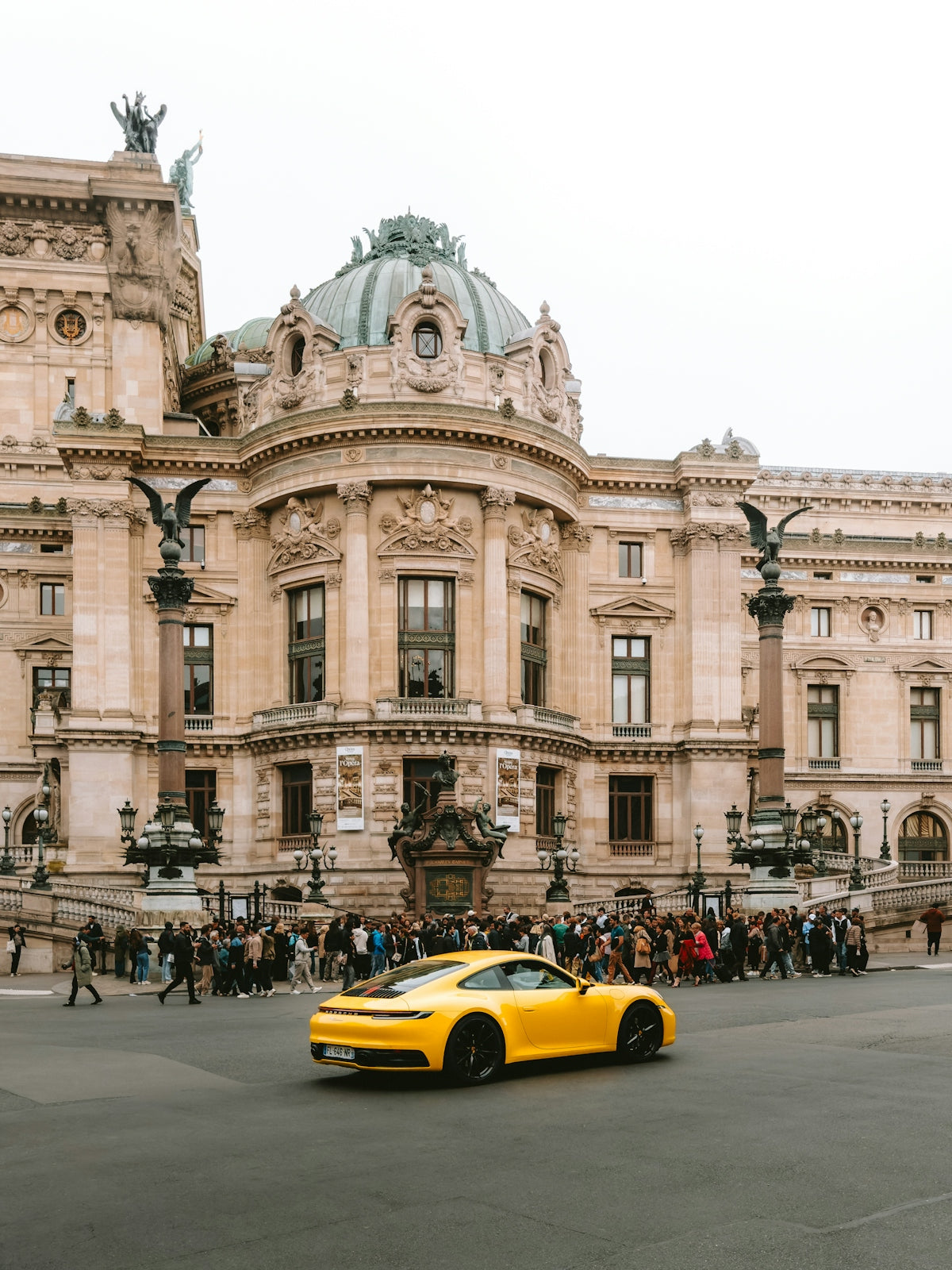 Yellow sports car in front of ornate building