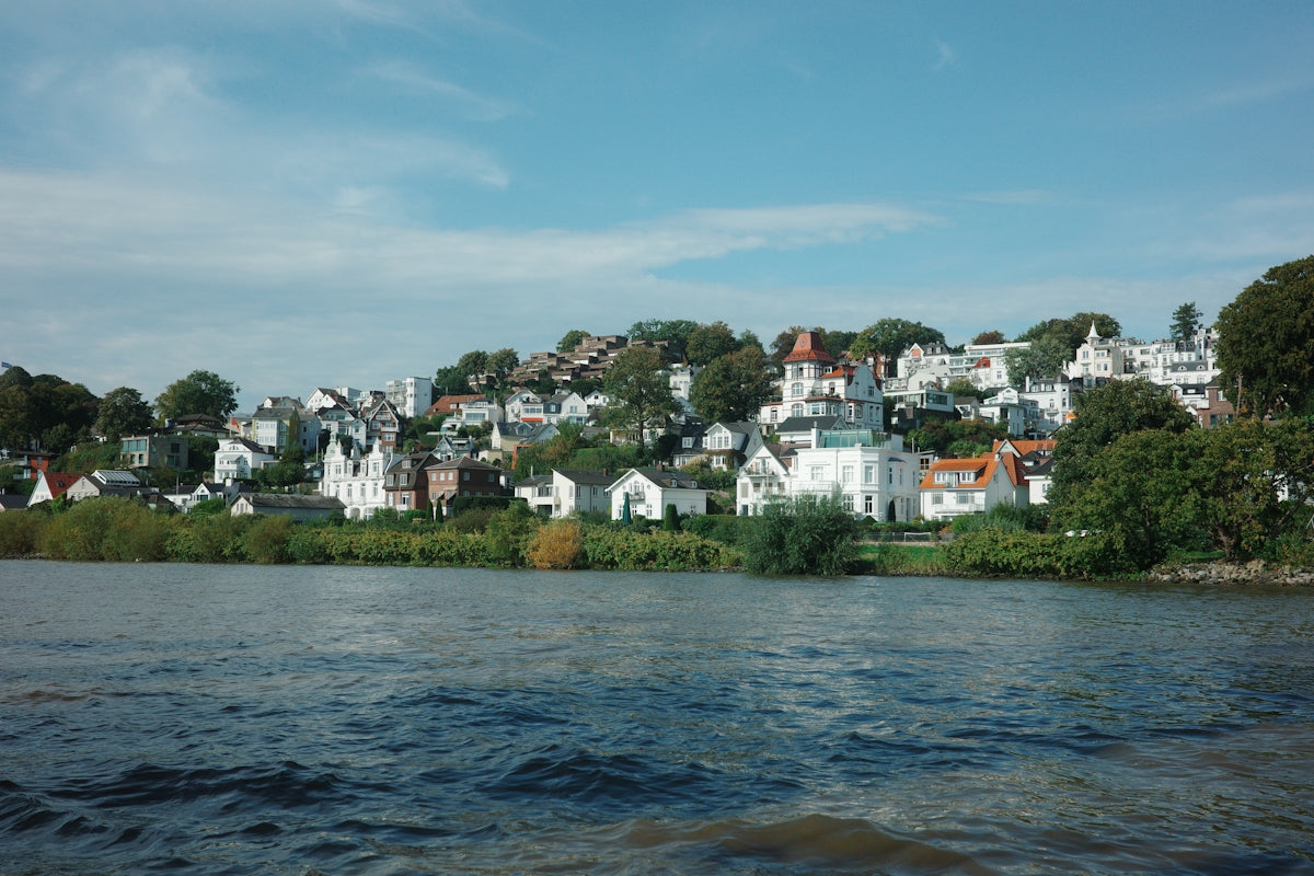 Waterfront view of a town on a hill.