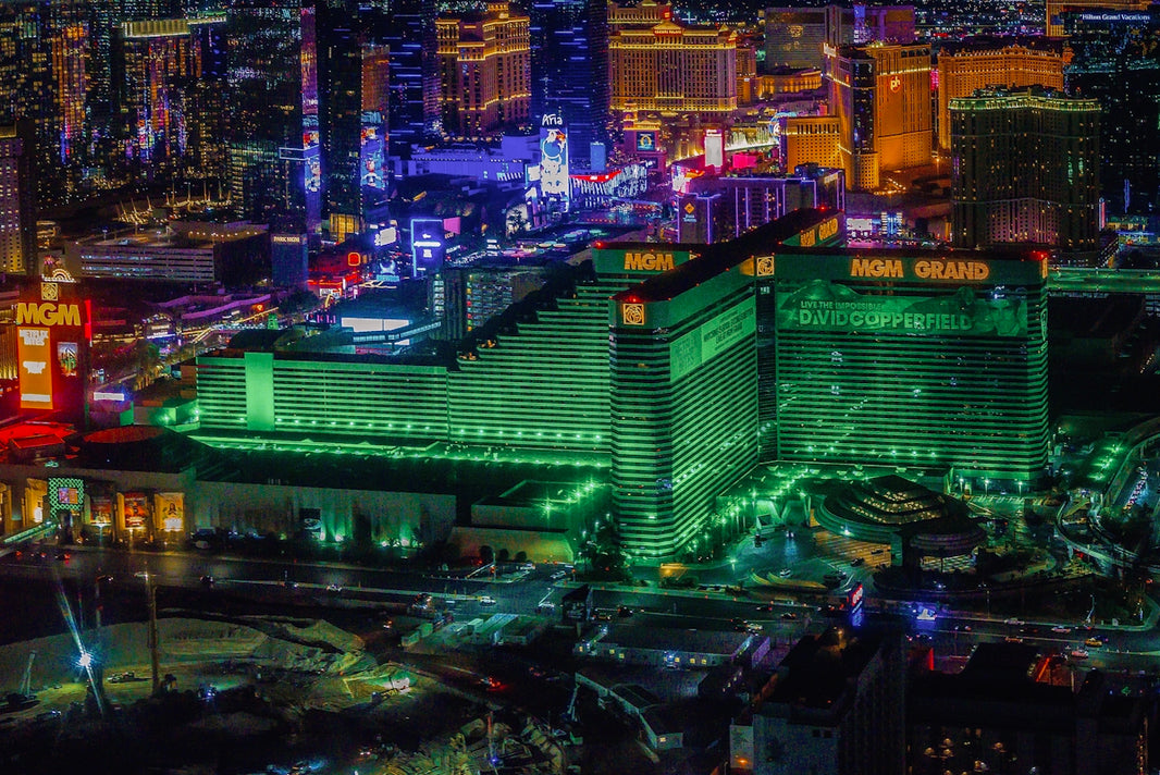Vibrant cityscape with illuminated buildings at night.