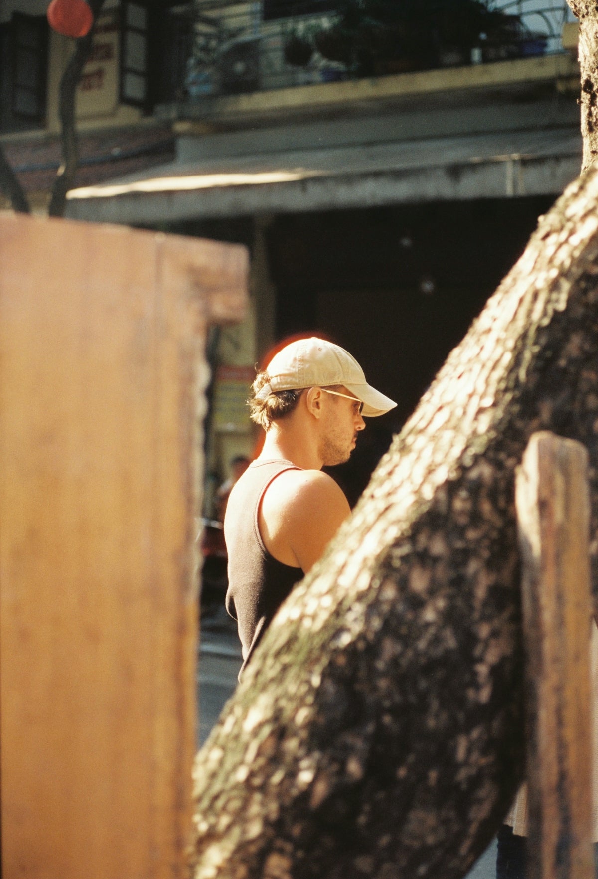 Person wearing a baseball cap and sunglasses outdoors.