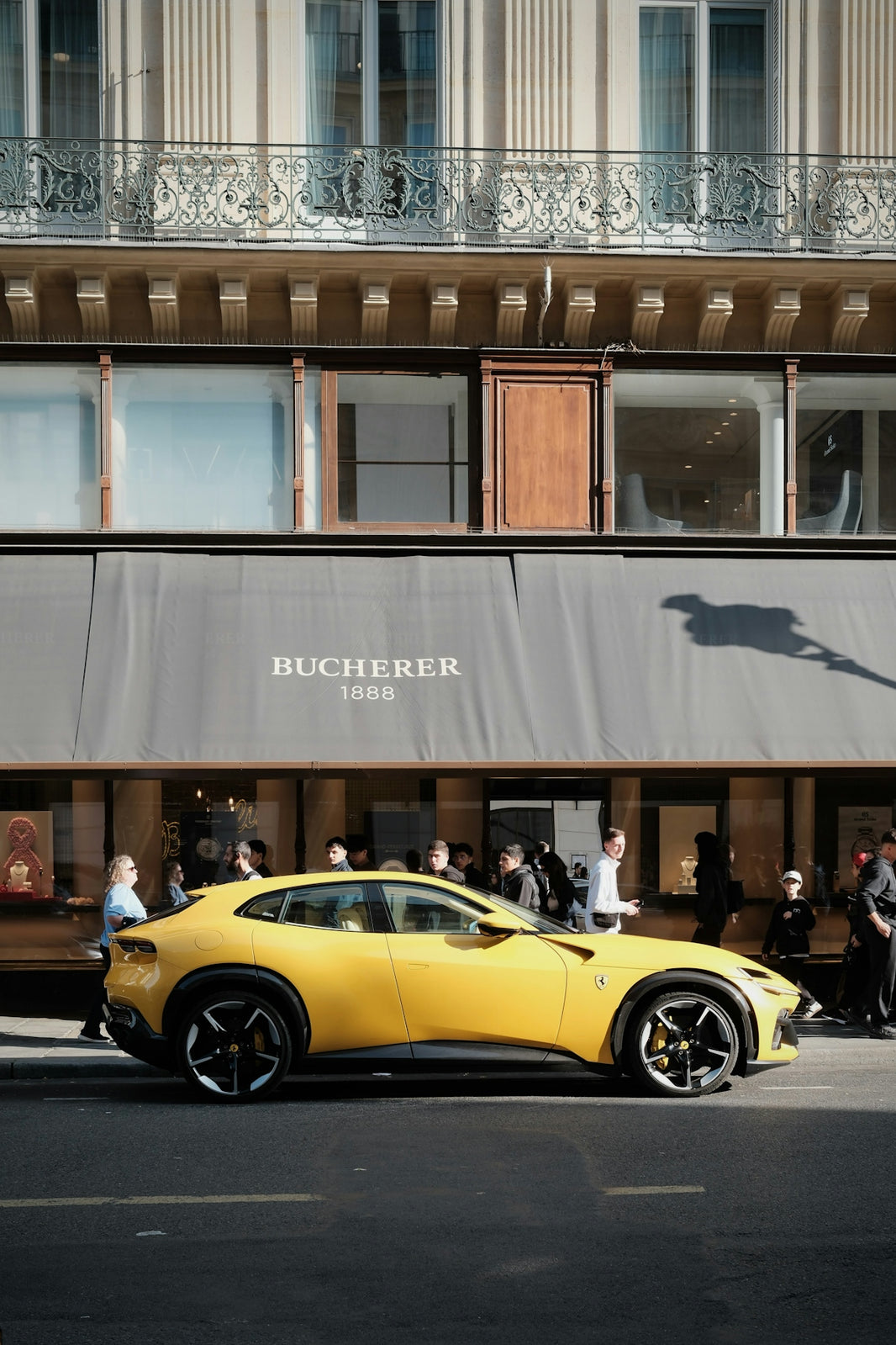 Yellow luxury car parked outside bucherer store