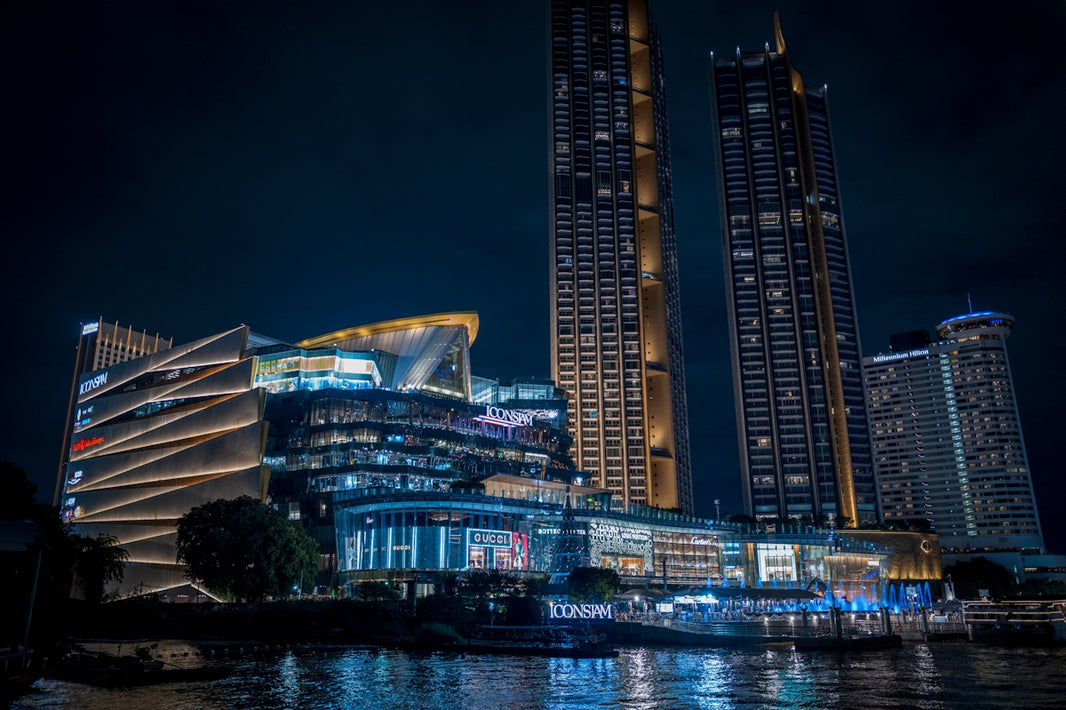 Modern illuminated buildings at night by the water