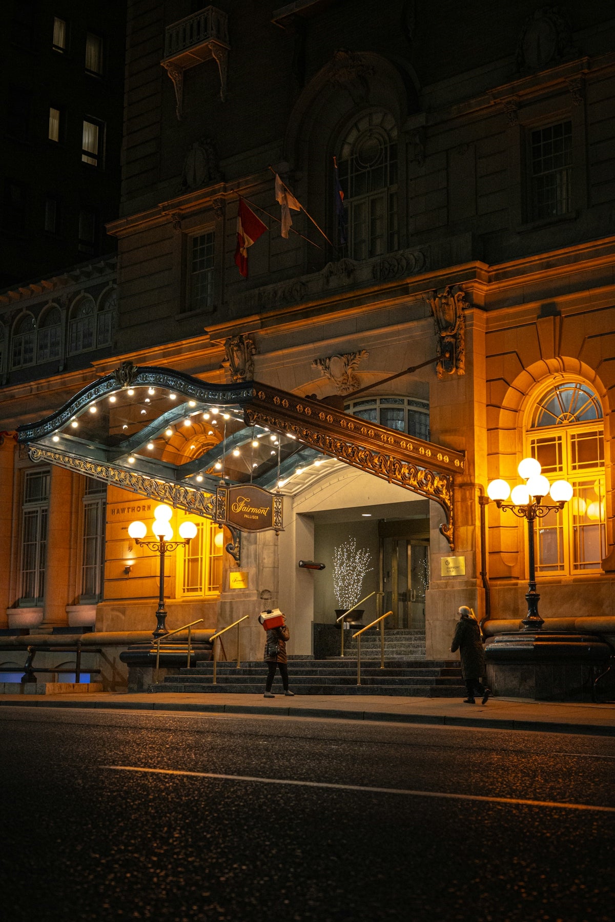 Grand hotel entrance illuminated at night