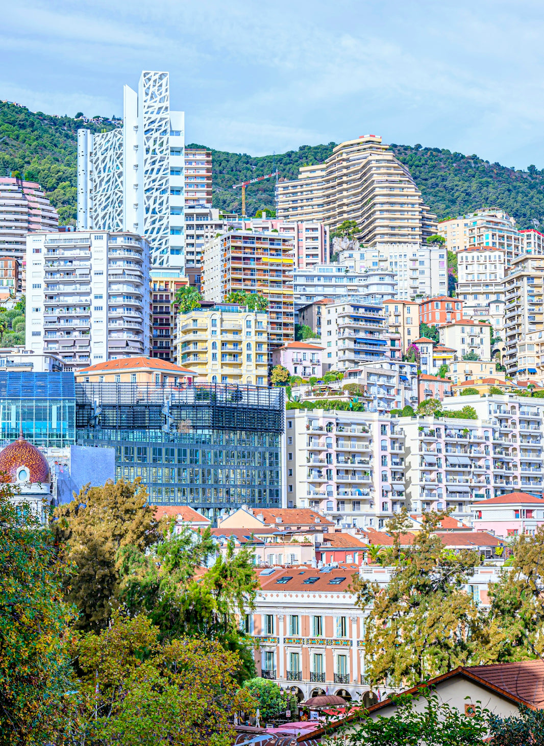Modern buildings on a green hillside under a blue sky