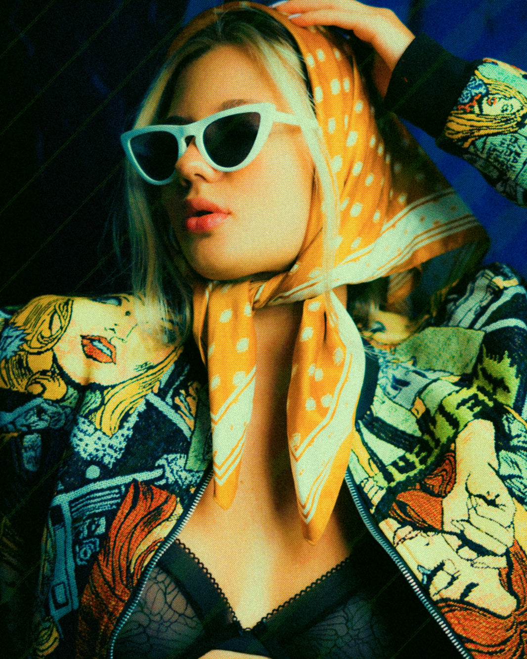 Woman wearing sunglasses and a patterned scarf