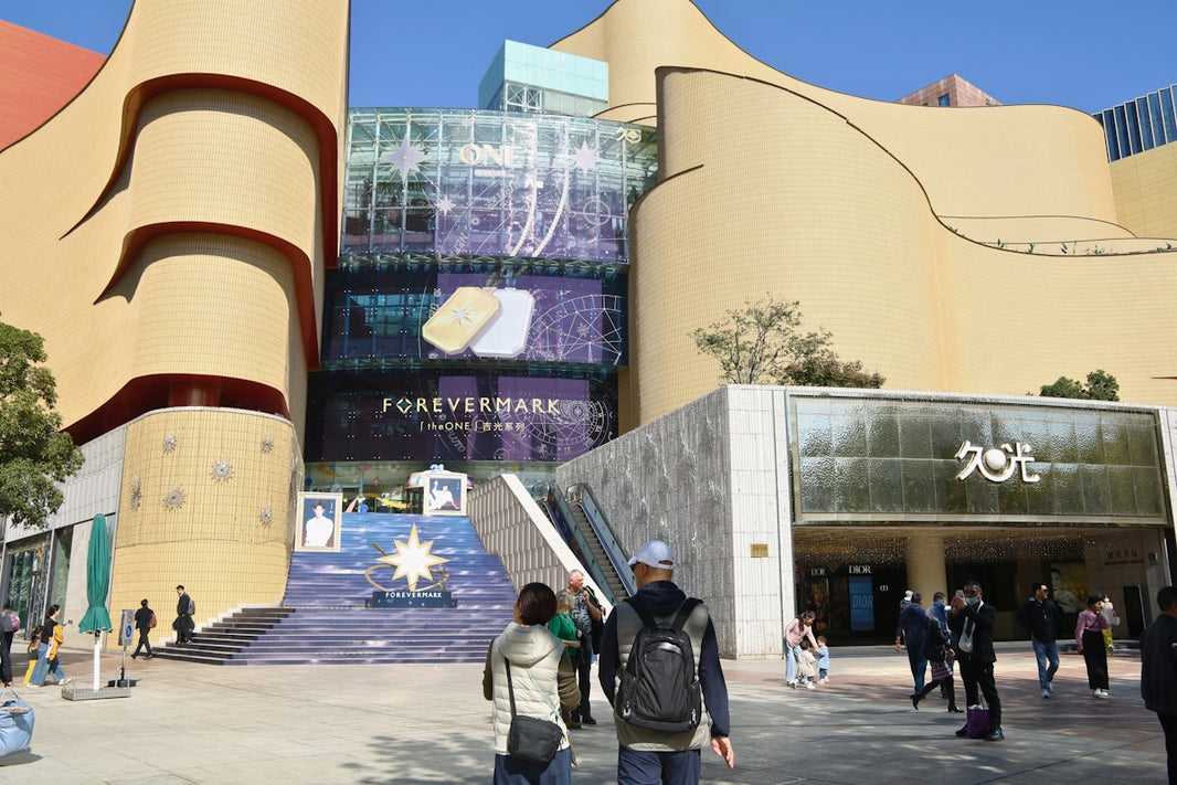Modern building with escalators and people walking