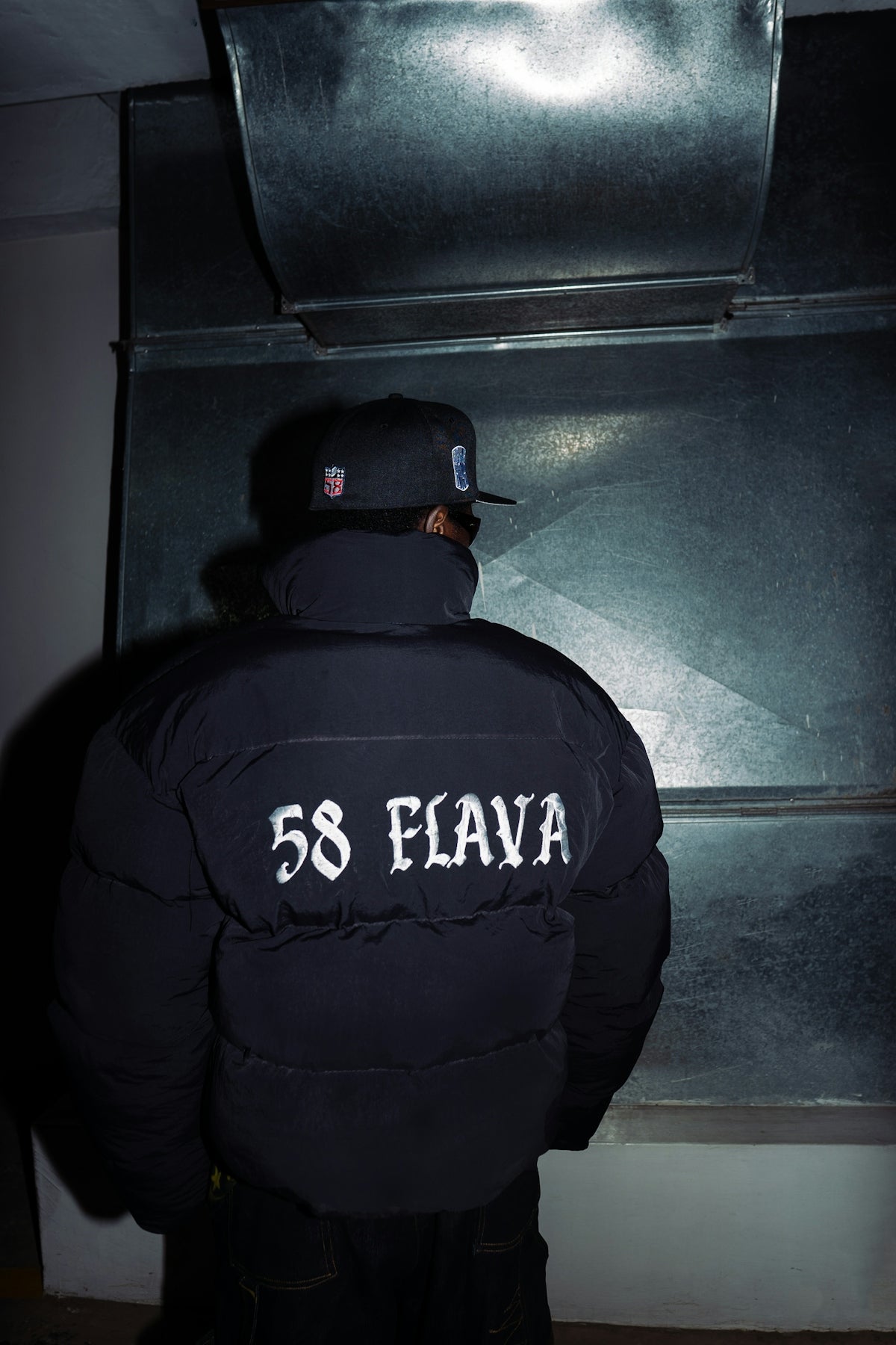 Person in puffer jacket with 58 flava on back