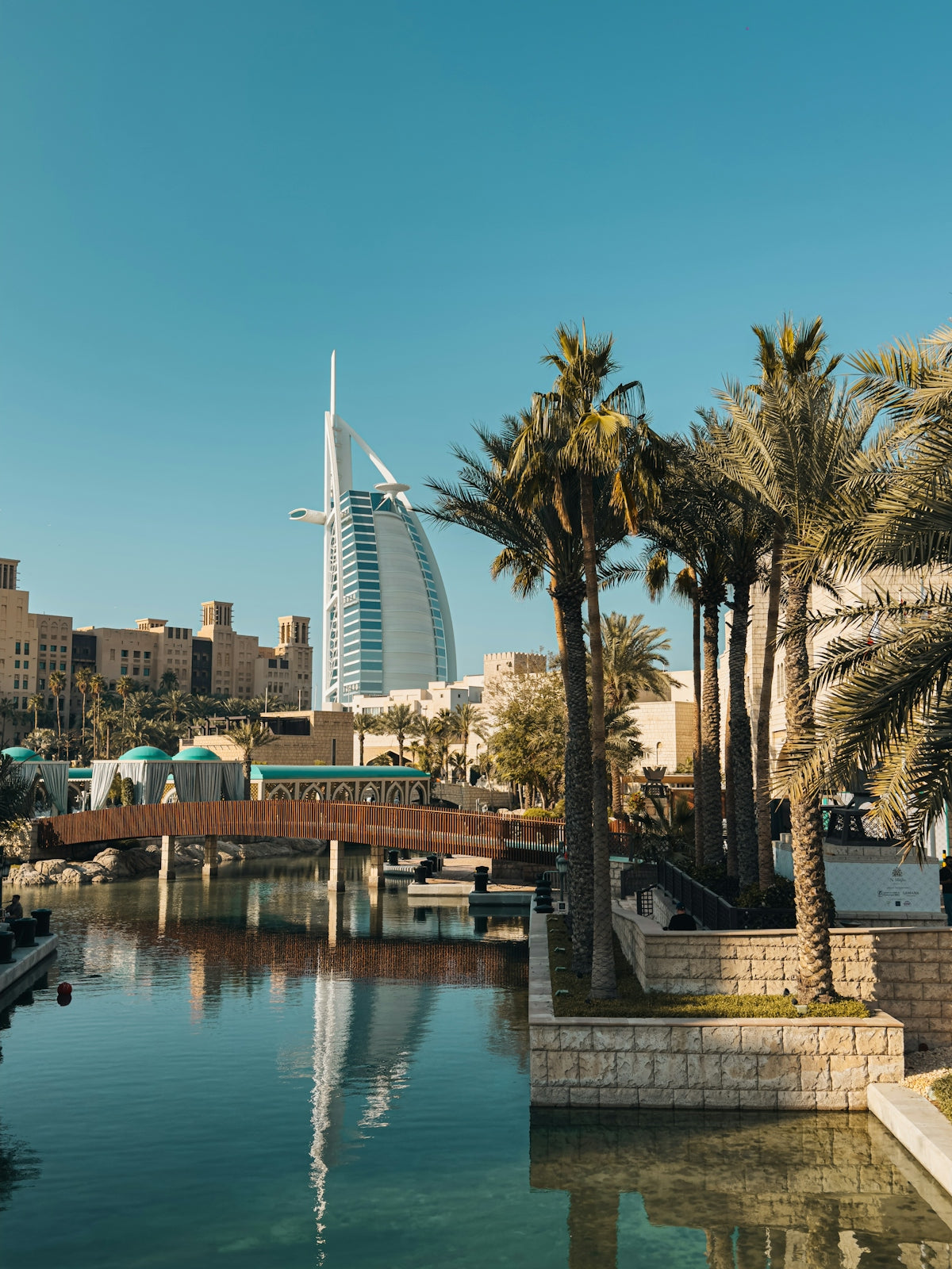 Modern hotel with palm trees and a canal