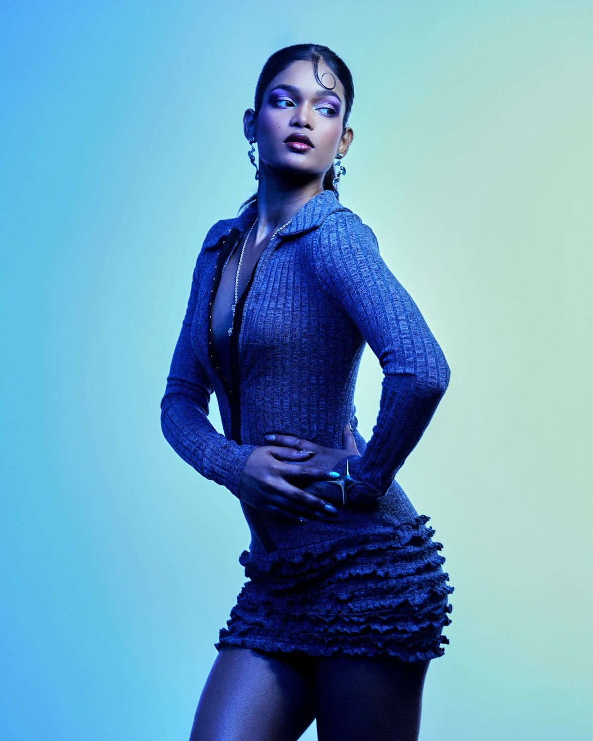A woman in a blue outfit with purple makeup