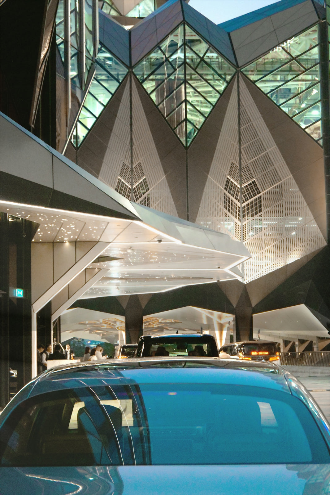 Modern building entrance with cars waiting