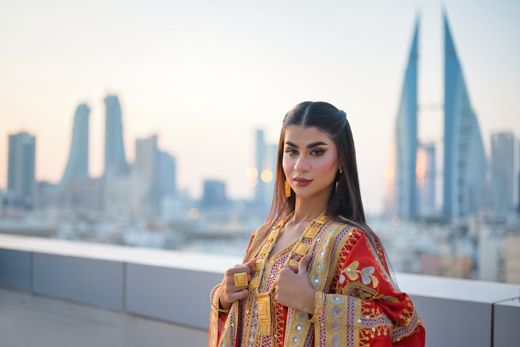Woman in traditional attire with cityscape background