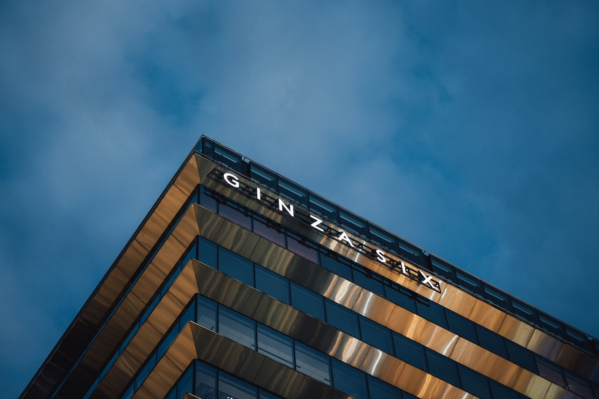 Modern building with ginzala sign against blue sky
