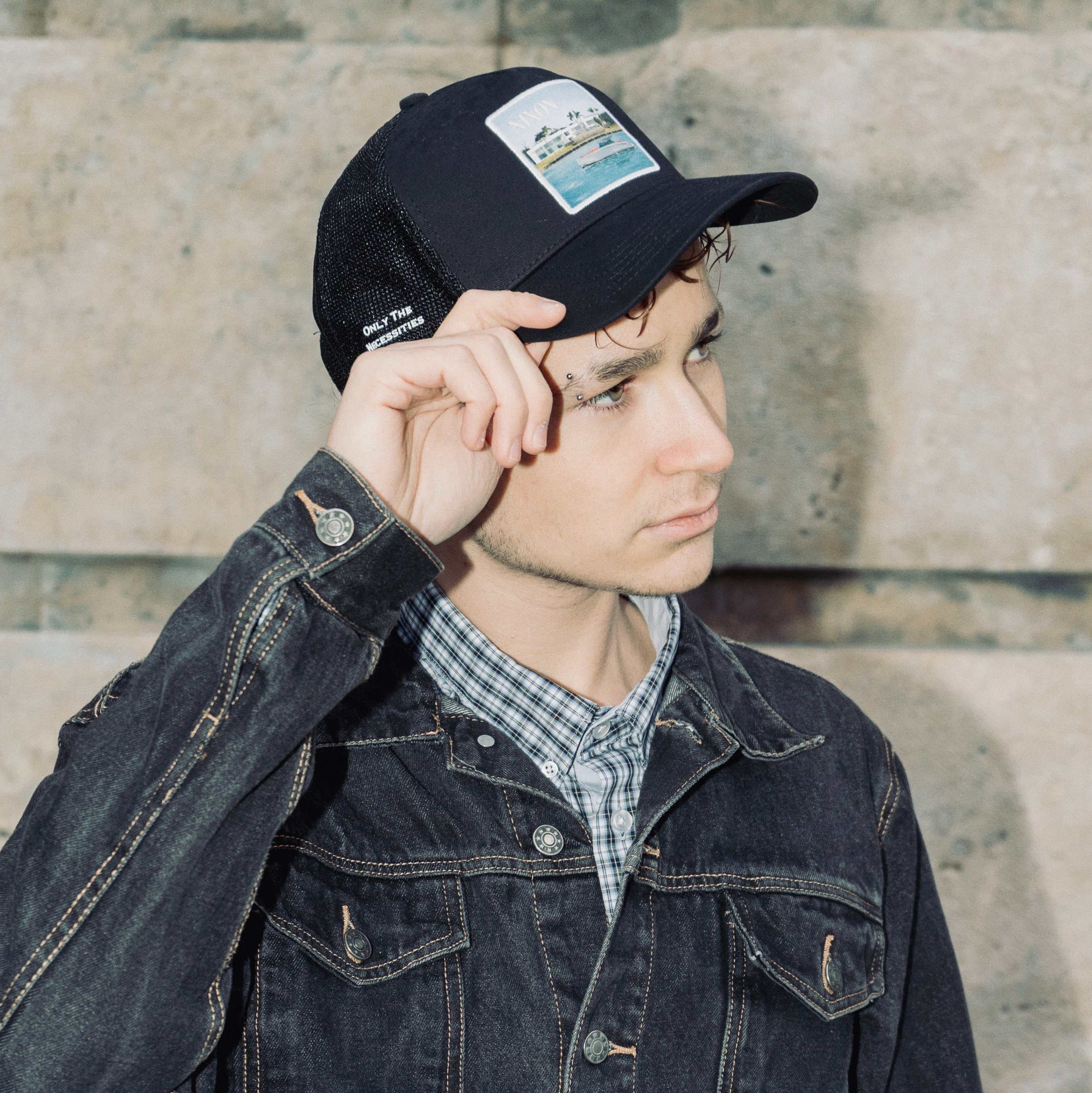Black Nixon Mesh-Back Trucker Hat with curved brim and embroidered patch