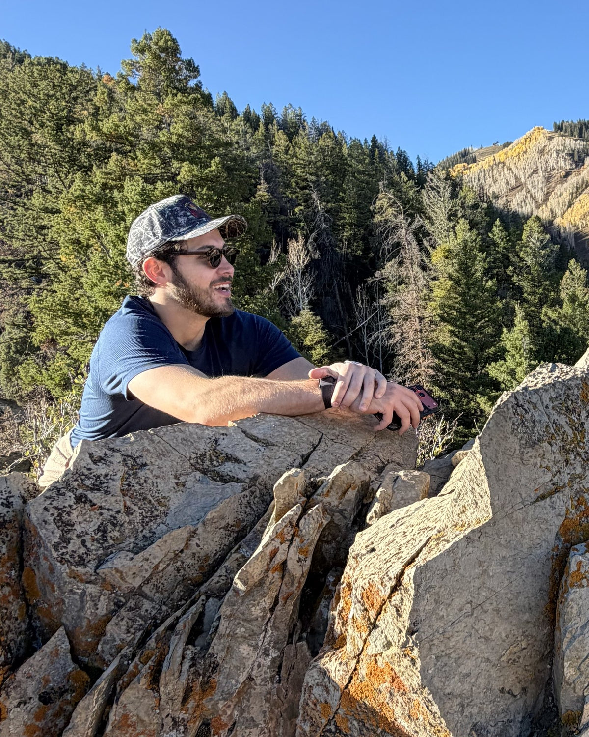 Daniel Lopez, founder of Places | Moments, on a rocky ridge in the mountains