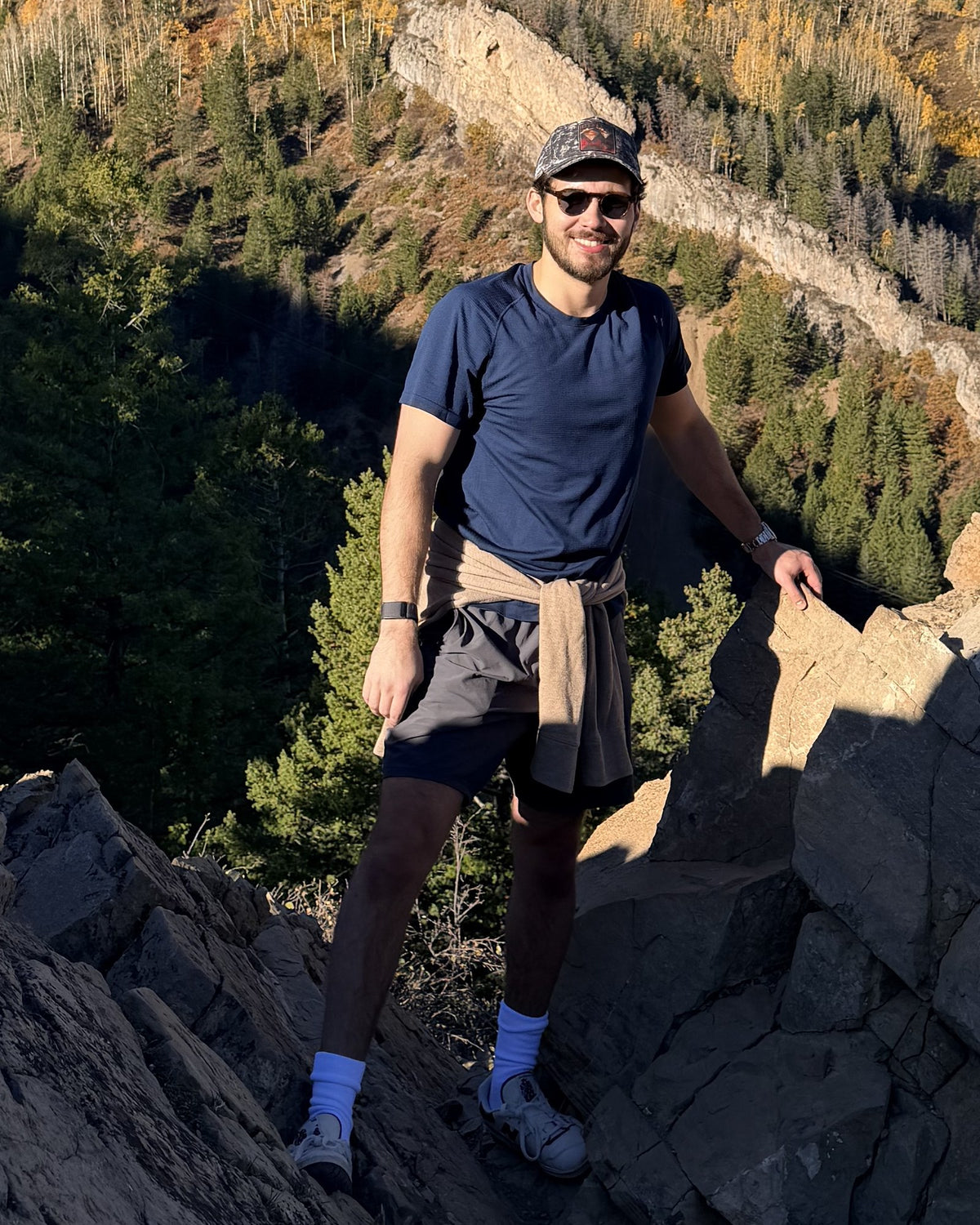 Daniel Lopez, founder of Places Moments, standing on a rocky mountain trail