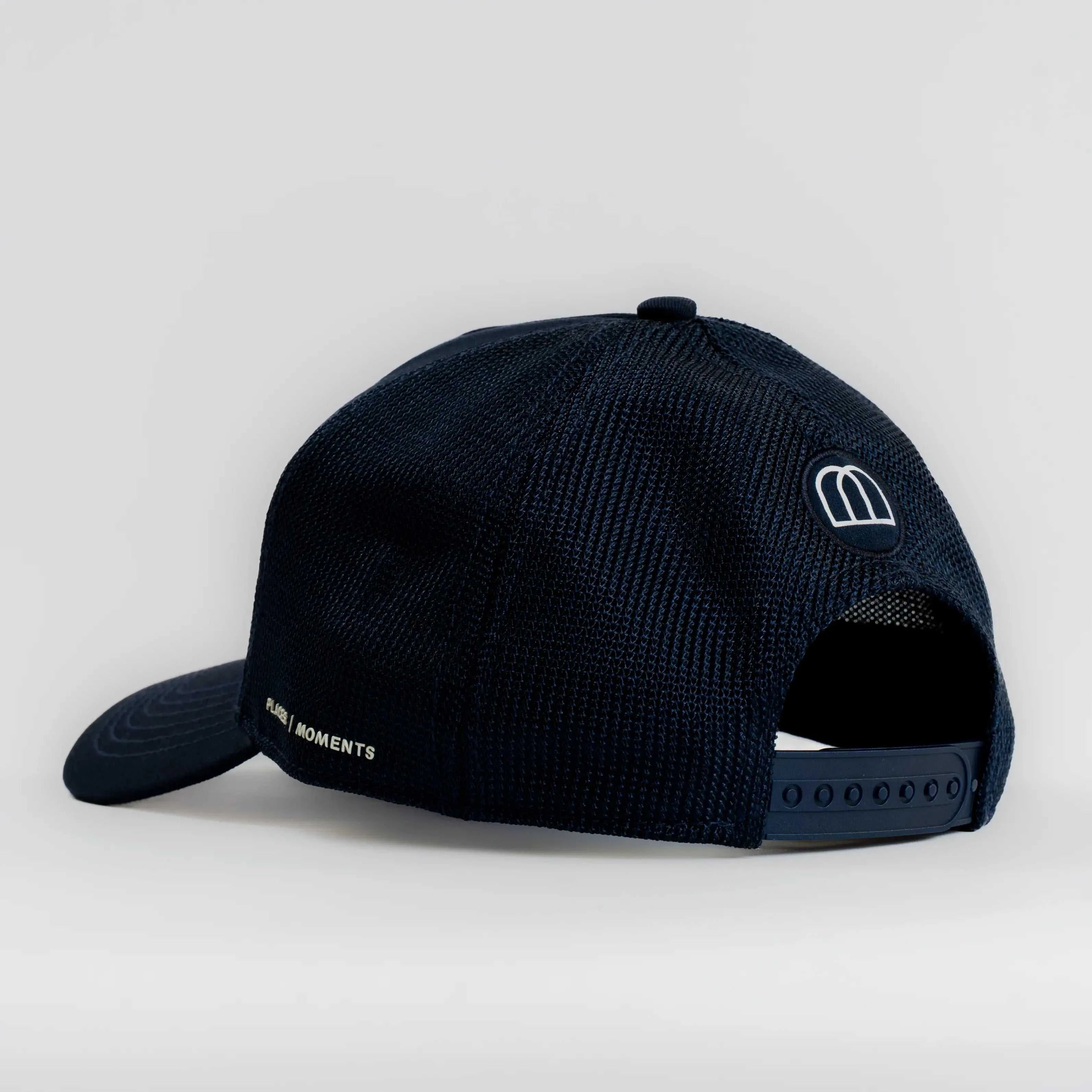 Côte Mesh-Back Trucker Hat in Indie Blue with structured front panel and breathable mesh back, featuring Places | Moments signature patch.