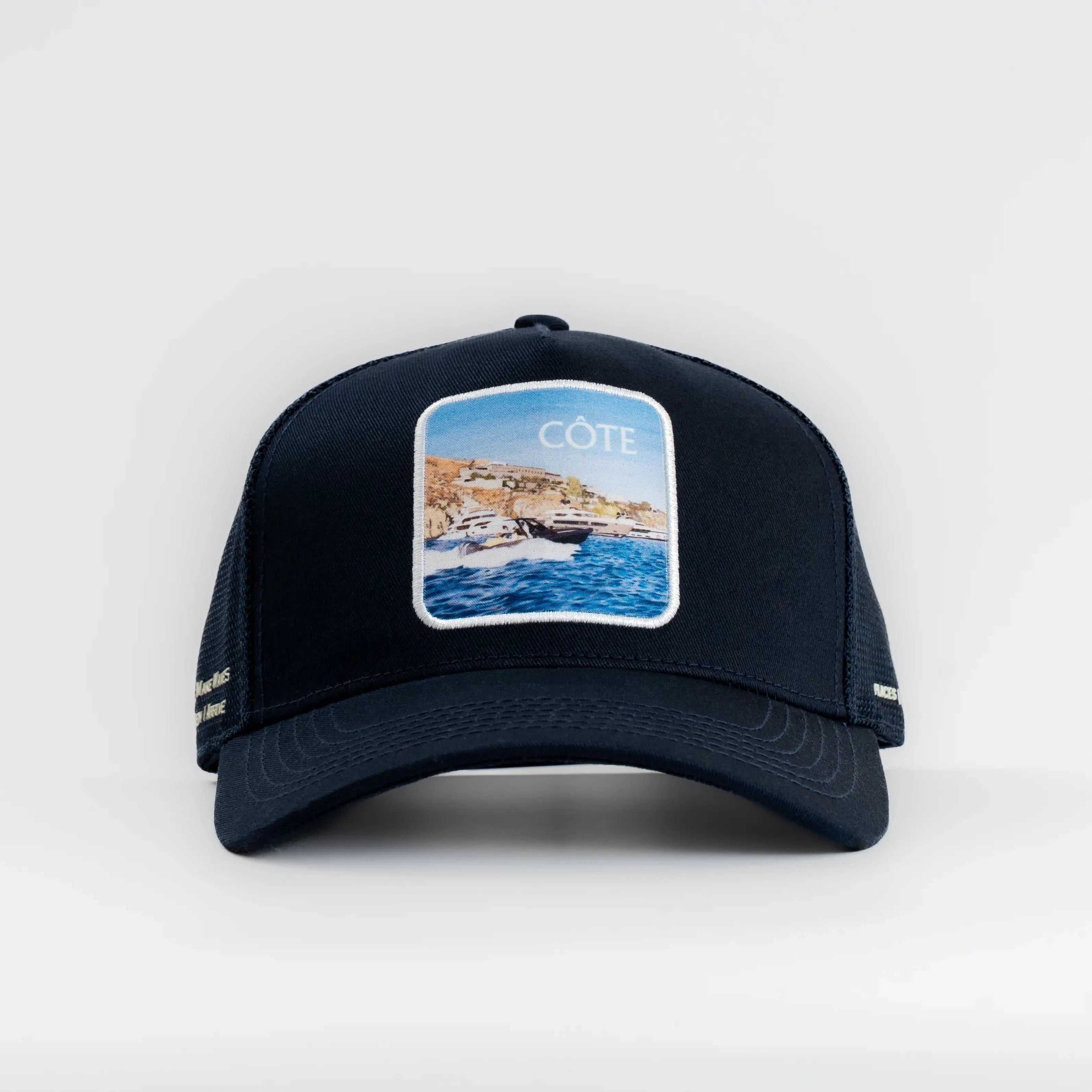 Côte Mesh-Back Trucker Hat in indie blue with coastal patch and breathable mesh back