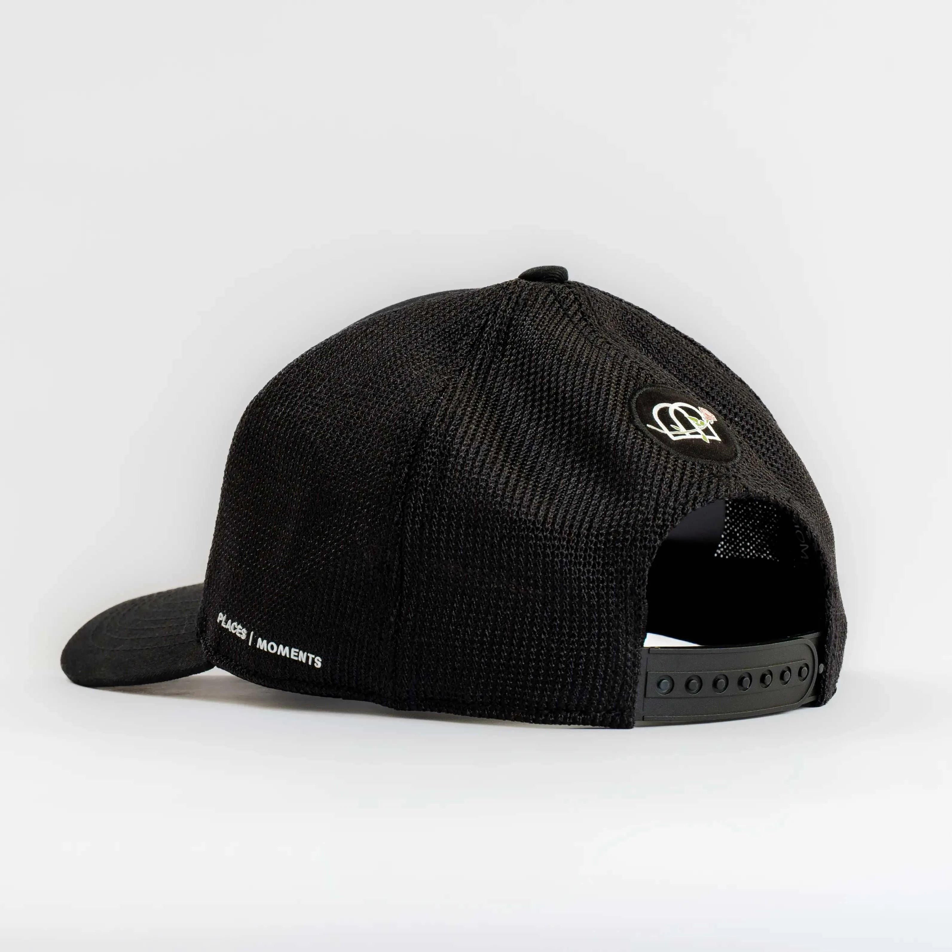 Dirty Martini Trucker Hat in Nightcap Black with mesh back and Places Moments branding.