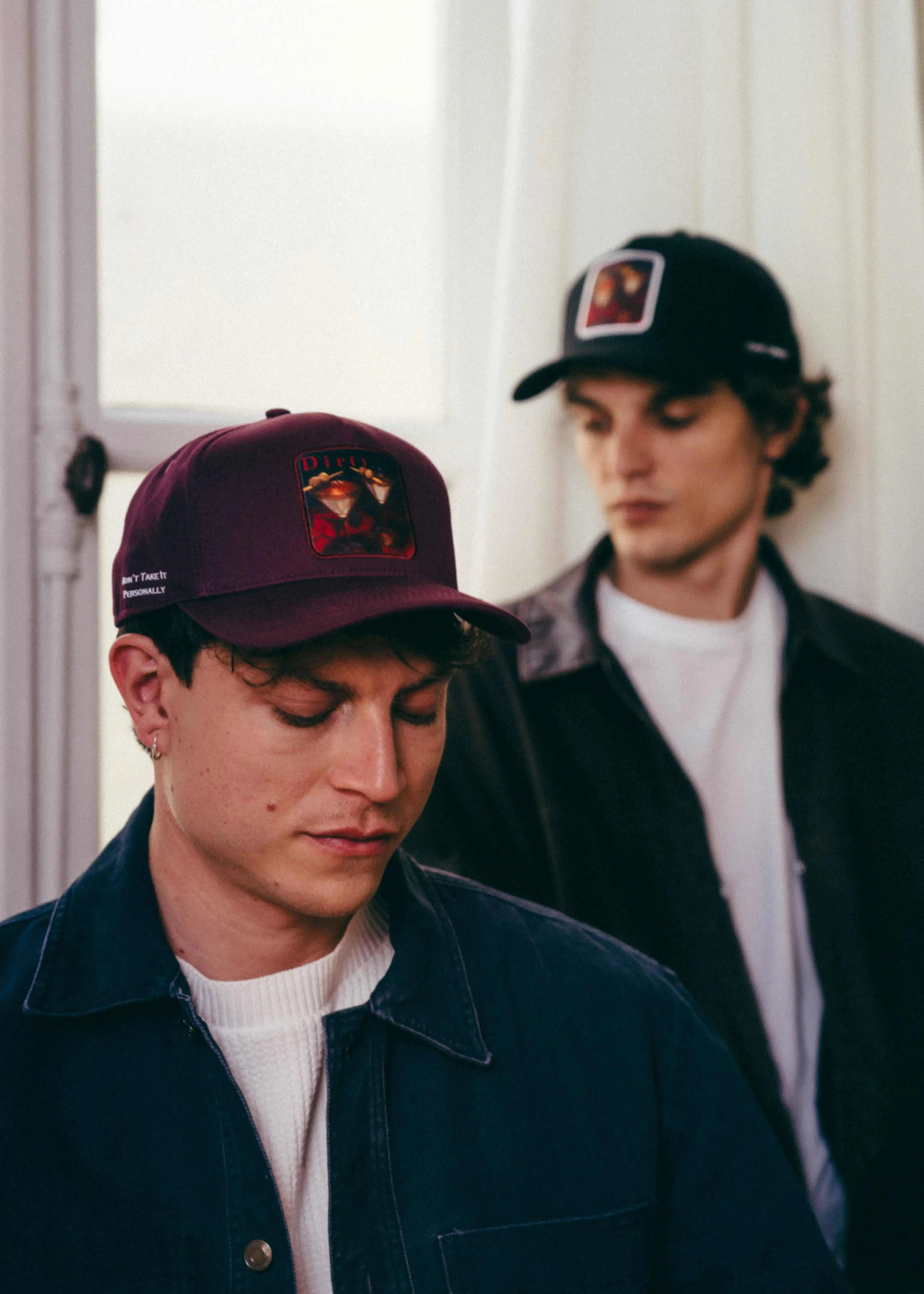 Men wearing Dirty Martini Baseball Caps with bold patches and stylish casual outfits