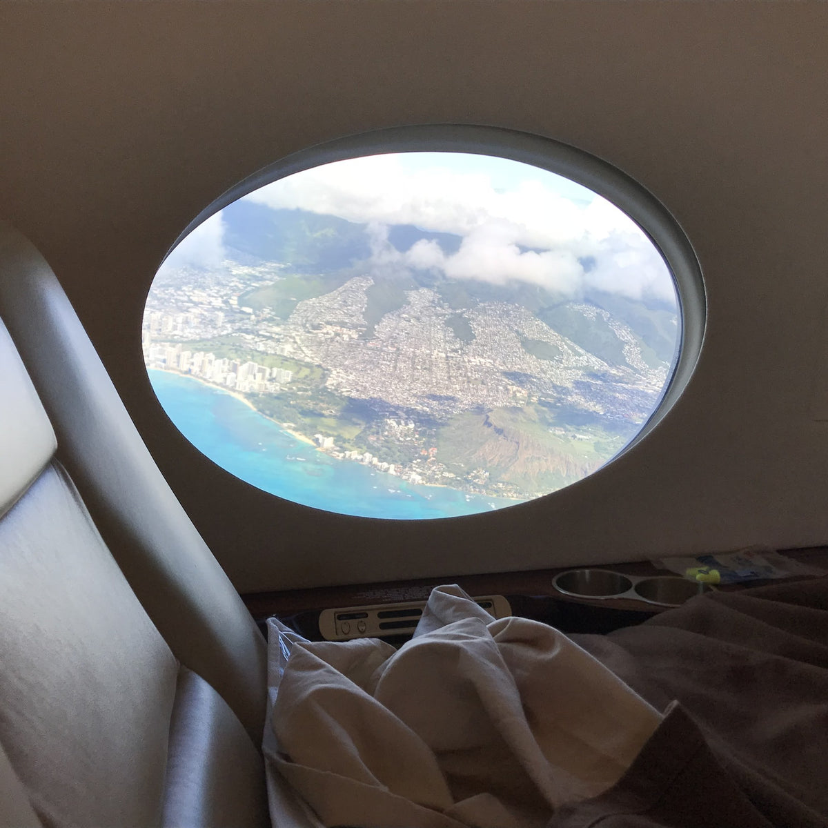 The photo out an oval airplane window that the Ovals painting started from
