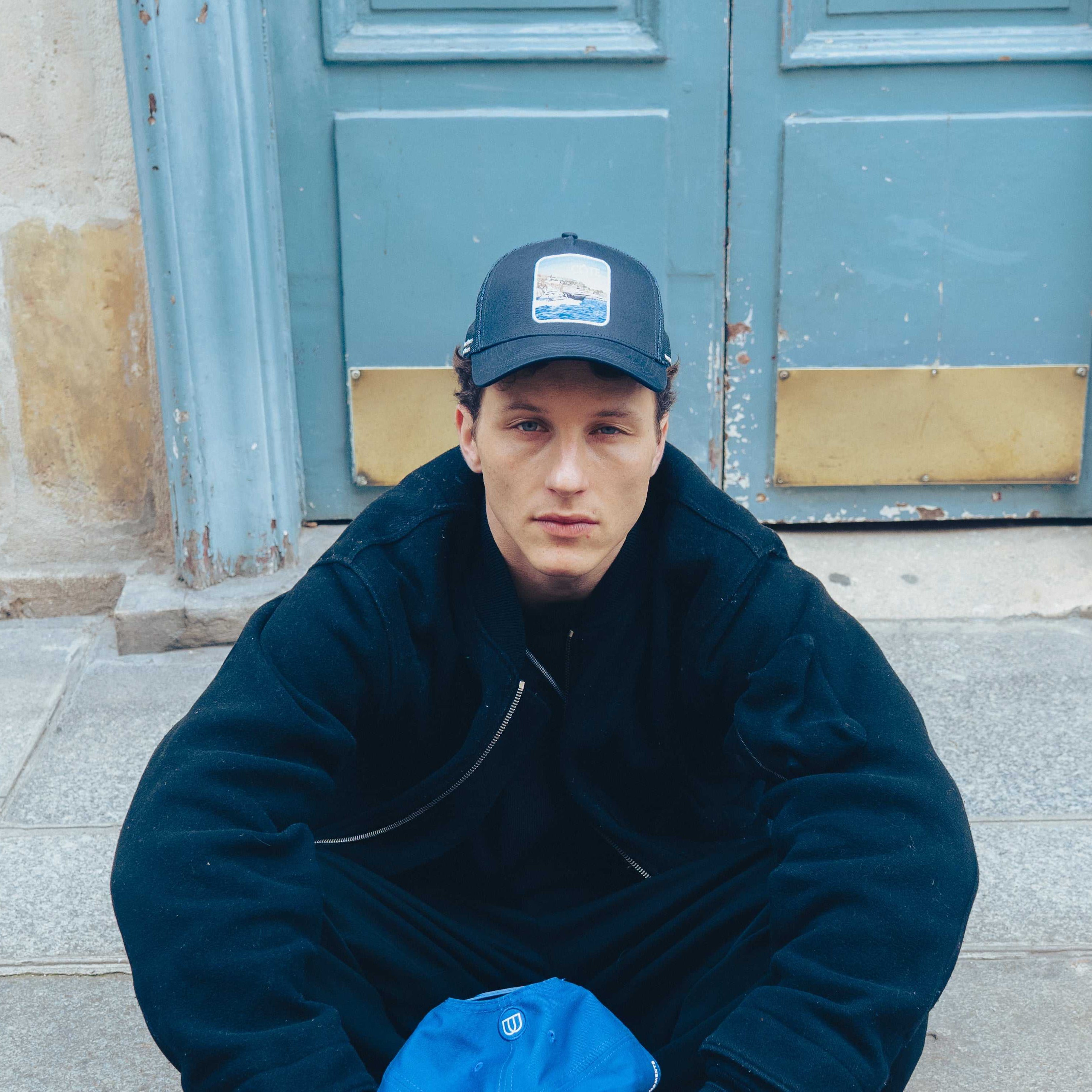 Côte Mesh-Back Trucker Hat in indie blue with breathable mesh back and signature patch