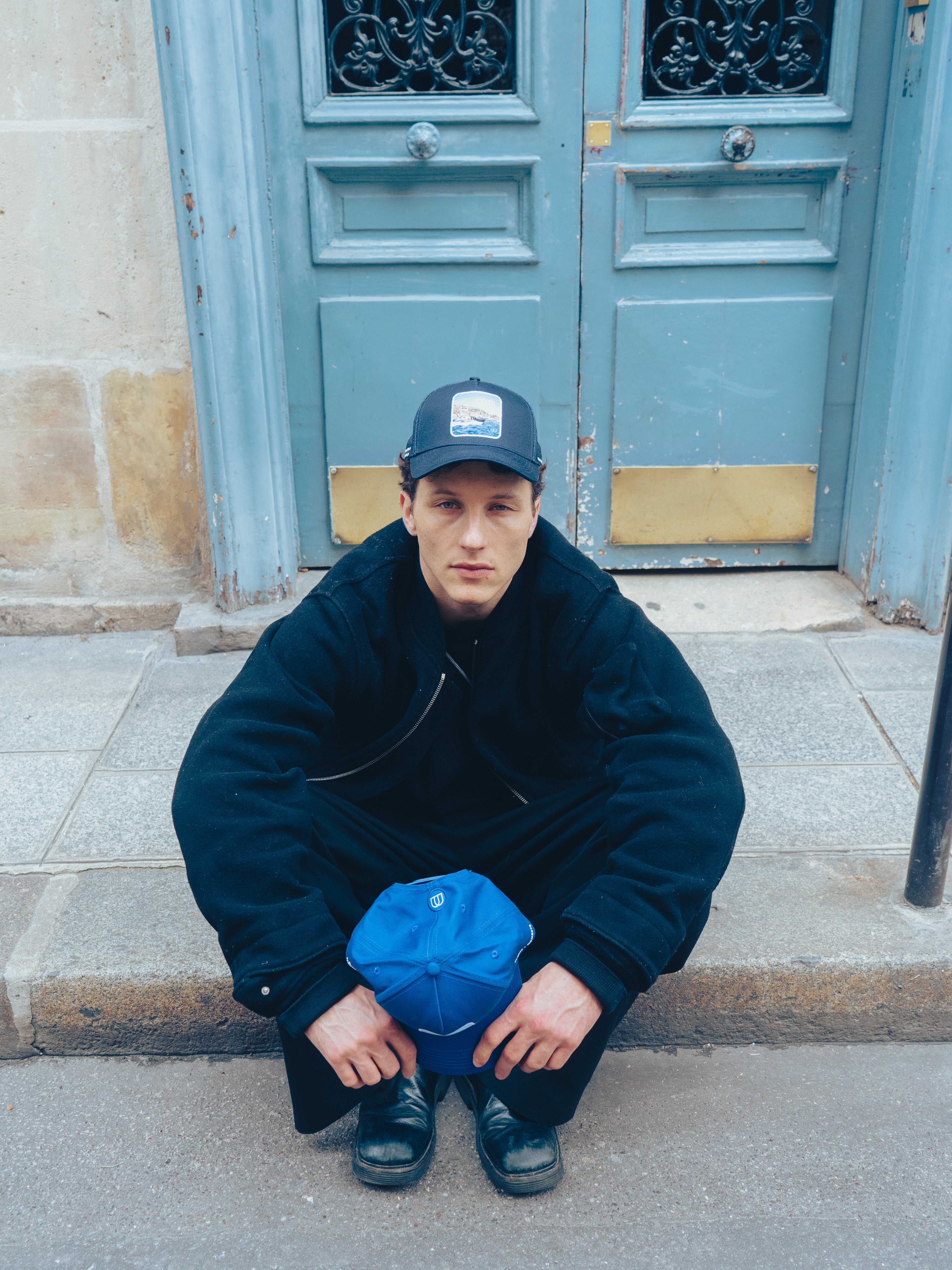 Côte Mesh-Back Trucker Hat in indie blue with breathable mesh back and signature patch