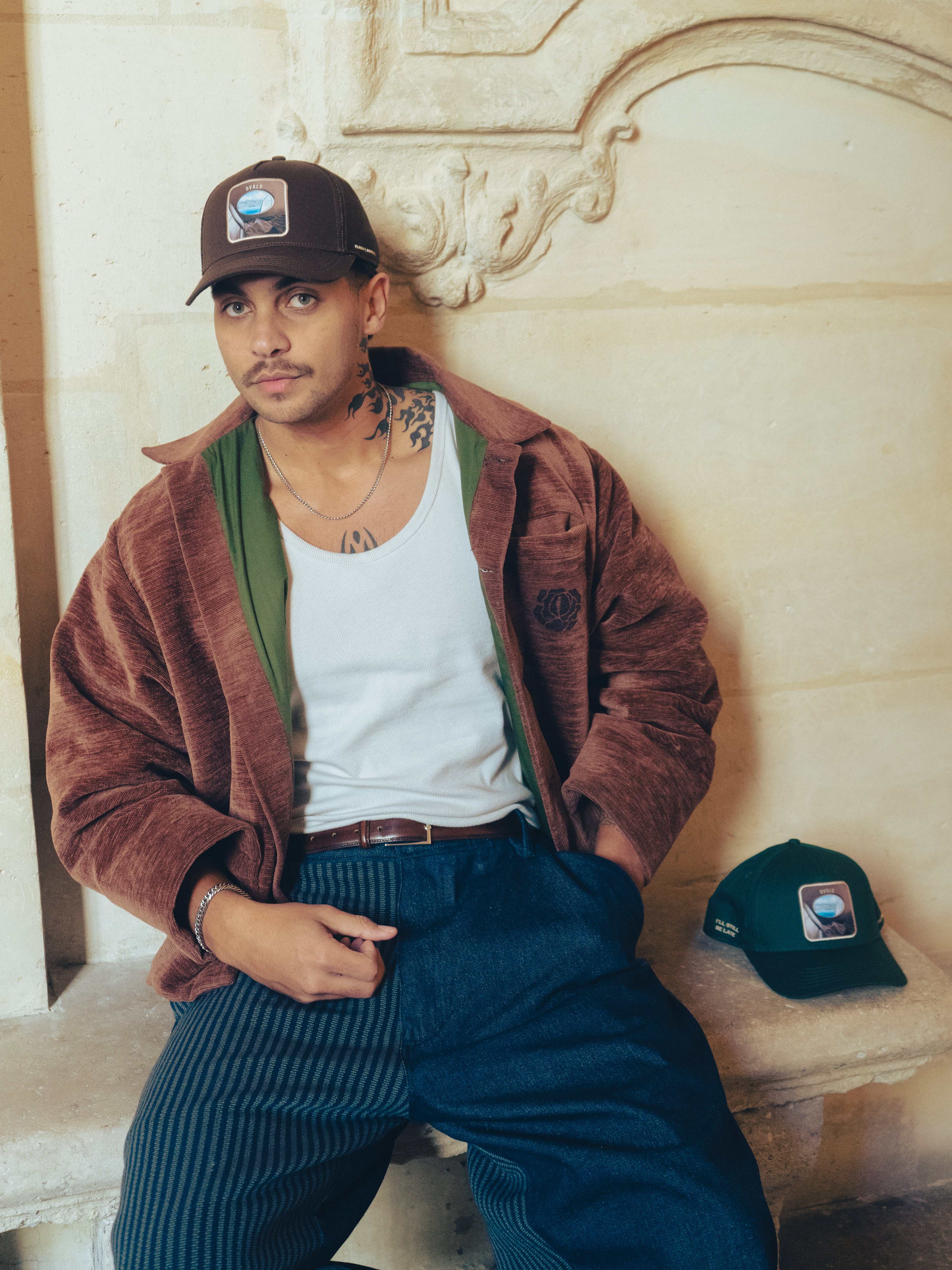 Brown Ovals Mesh-Back Trucker Hat with chestnut front, tan mesh back, curved brim, and embroidered patch
