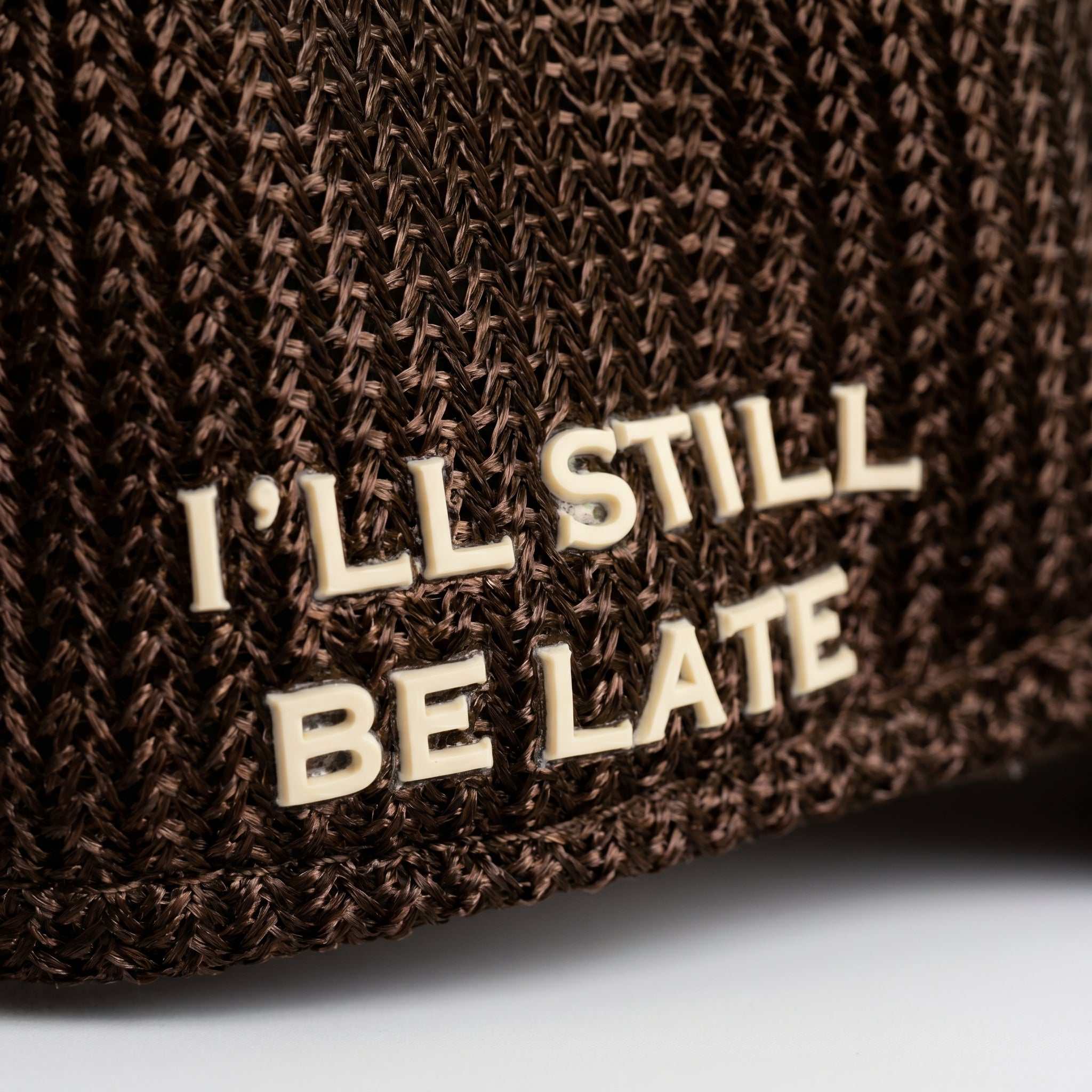 Brown Ovals Mesh-Back Trucker Hat with chestnut front, tan mesh back, curved brim, and embroidered patch