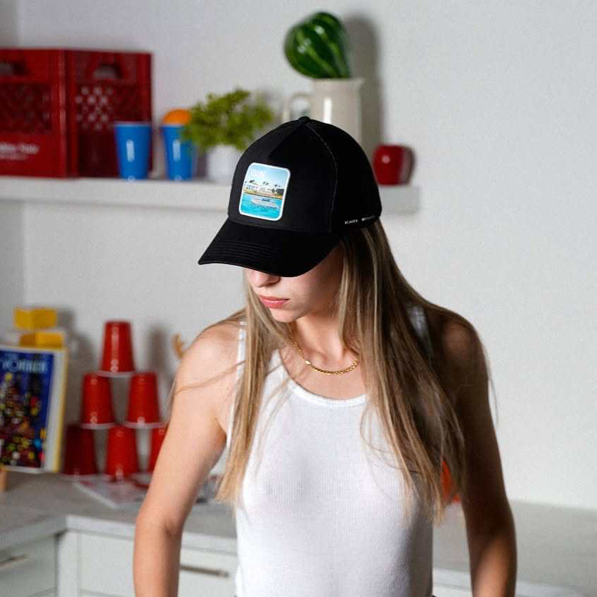 Black Nixon Mesh-Back Trucker Hat with embroidered Places | Moments patch and curved brim