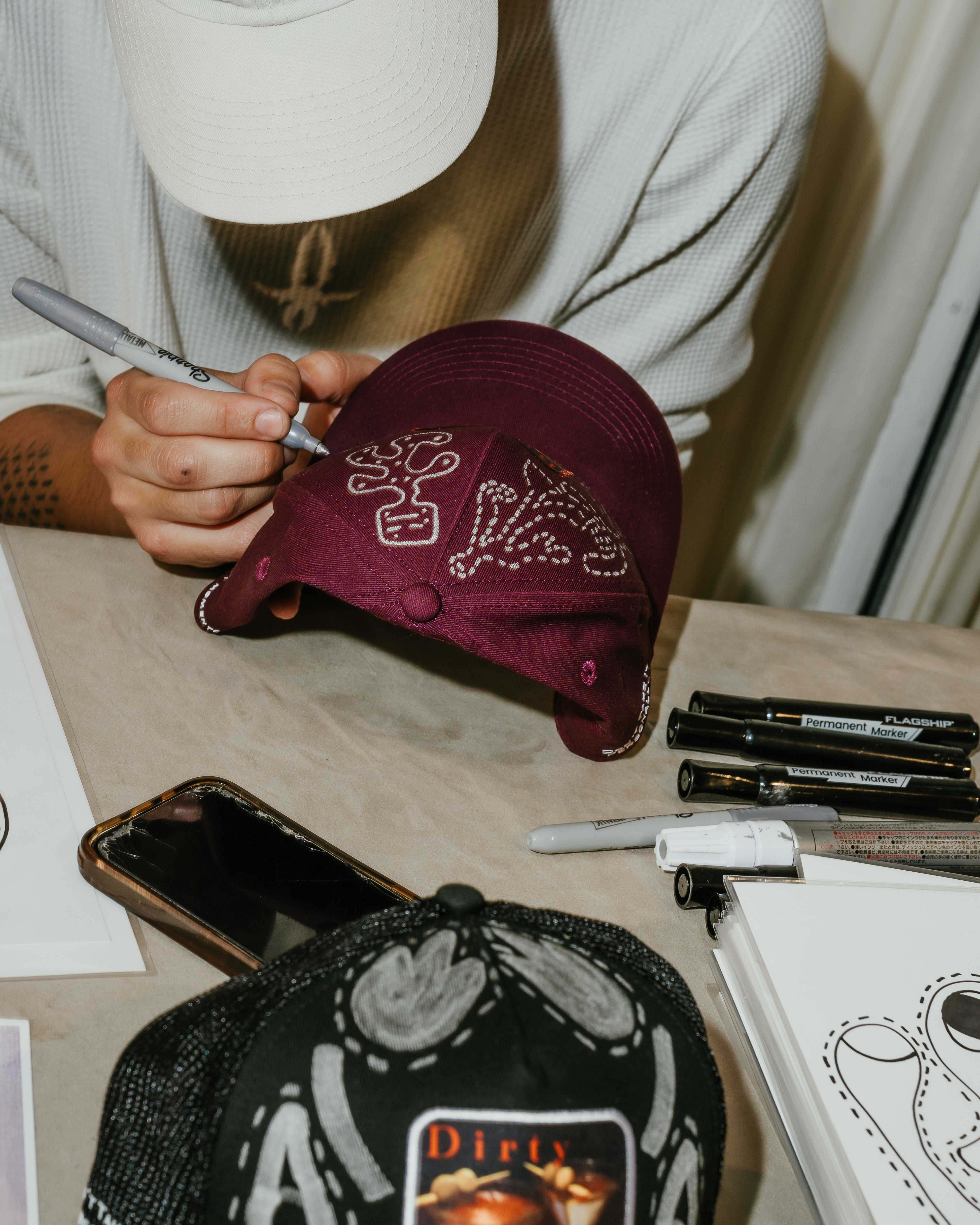 Dirty Martini x Muji limited edition red baseball cap with hand-drawn artwork and adjustable fit